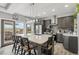 Gray modern kitchen with large island and breakfast bar area with pendant lighting at 3595 W 67Th S Ave, Denver, CO 80221