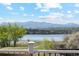 Scenic view of a lake and mountains, framed by a deck railing in the foreground at 3595 W 67Th S Ave, Denver, CO 80221