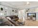 Spacious living room with a fireplace, plush seating, and natural light at 3595 W 67Th S Ave, Denver, CO 80221