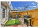 Cozy fenced patio featuring an umbrella-shaded table, grill, and artificial turf at 7973 Chase Circle # 54, Arvada, CO 80003