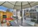 A relaxing shaded patio with an umbrella, table, and a grill at 7973 Chase Circle # 54, Arvada, CO 80003