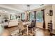 Charming dining room featuring hardwood floors and an open view of the living room at 5843 Ceylon St, Denver, CO 80249