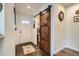 Welcoming entryway with a rustic barn door and tiled flooring at 5843 Ceylon St, Denver, CO 80249