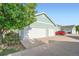 View of home with a 3 car garage and a clean driveway at 5843 Ceylon St, Denver, CO 80249