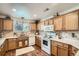 Well-lit kitchen with oak cabinets and a tiled backsplash at 5843 Ceylon St, Denver, CO 80249