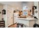 Charming kitchen with wood cabinets, white appliances, pantry, and breakfast bar at 5843 Ceylon St, Denver, CO 80249