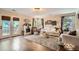 Cozy living room with a fireplace, plush seating, and ample natural light at 5843 Ceylon St, Denver, CO 80249
