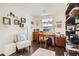 Bright home office featuring hardwood floors, a spacious desk, and stylish decor at 5843 Ceylon St, Denver, CO 80249