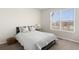 Bright bedroom featuring a neutral color palette, plush bedding, and a large window that provides ample natural light at 4561 Hope Cir, Broomfield, CO 80023