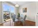 Bright dining area featuring a glass table with chairs, hardwood floors, and sliding doors to the outdoor deck at 4561 Hope Cir, Broomfield, CO 80023