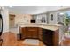 Bright kitchen with wooden cabinets, stainless steel appliances, and a breakfast bar overlooking the living area at 4561 Hope Cir, Broomfield, CO 80023