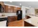 Well-equipped kitchen featuring wooden cabinets, stainless steel appliances, and a breakfast bar for casual dining at 4561 Hope Cir, Broomfield, CO 80023