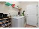 Functional laundry room equipped with a washer, dryer, and shelving for storage and organization at 4561 Hope Cir, Broomfield, CO 80023