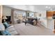 Cozy living room with a comfortable sofa, large window, and a view to the dining area and kitchen at 4561 Hope Cir, Broomfield, CO 80023