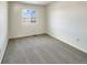 Well-lit bedroom with grey carpet and a view from the window at 2020 Alpine Dr, Erie, CO 80516