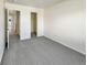 Bright bedroom featuring grey carpeting and built-in closet at 2020 Alpine Dr, Erie, CO 80516