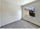 Bright bedroom with gray carpeting and large window at 2020 Alpine Dr, Erie, CO 80516