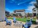 Private backyard with a stone fire pit and Adirondack chairs, perfect for outdoor gatherings at 4858 S Tibet St, Aurora, CO 80015