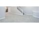Finished basement with carpeted floors, stairway, and access to kitchen area at 4858 S Tibet St, Aurora, CO 80015