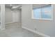 Finished basement area with a daylight egress window and neutral colored carpet at 4858 S Tibet St, Aurora, CO 80015