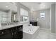Large bathroom offering a soaking tub, dual vanities, and a separate shower at 4858 S Tibet St, Aurora, CO 80015