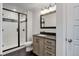 Modern bathroom boasts a glass shower and a stylish vanity with storage at 4858 S Tibet St, Aurora, CO 80015