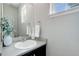 Bright half bathroom featuring a sleek vanity, mirror, and fresh decor at 4858 S Tibet St, Aurora, CO 80015