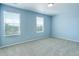 Bedroom featuring blue walls, carpet, and a window at 4858 S Tibet St, Aurora, CO 80015