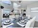 Dining area adjacent to the living room and kitchen features stylish furnishings and decorative tableware at 4858 S Tibet St, Aurora, CO 80015