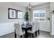 Elegant dining room with a modern chandelier and ample natural light from the large window at 4858 S Tibet St, Aurora, CO 80015