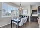 Cozy dining area with window views, stylish chandelier, and contemporary decor at 4858 S Tibet St, Aurora, CO 80015