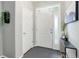 Bright entryway with a white front door with sidelight, sleek console table and minimalist decor at 4858 S Tibet St, Aurora, CO 80015
