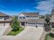 Beautiful exterior elevation of home with three-car garage, new landscaping, and inviting entry at 4858 S Tibet St, Aurora, CO 80015