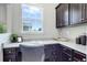 A built-in desk and cabinets are situated by a window in this modern home office at 4858 S Tibet St, Aurora, CO 80015