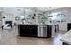 Kitchen island with stainless steel dishwasher and granite countertops offers ample prep space at 4858 S Tibet St, Aurora, CO 80015
