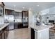 Modern kitchen with stainless steel appliances, granite countertops, and hardwood floors at 4858 S Tibet St, Aurora, CO 80015