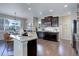 Bright kitchen features a large island, stainless steel appliances, and dark wood cabinets at 4858 S Tibet St, Aurora, CO 80015
