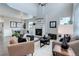 Open-concept living area featuring fireplace, high ceilings, wood floors, and stylish modern furnishings at 4858 S Tibet St, Aurora, CO 80015