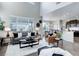 Spacious living room with a fireplace, high ceilings, and seamless transition to the dining and kitchen areas at 4858 S Tibet St, Aurora, CO 80015