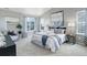 Light-filled main bedroom with vaulted ceilings, neutral décor, and sitting area by the window at 4858 S Tibet St, Aurora, CO 80015