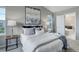 Bright main bedroom featuring stylish furniture and decor with a view to the adjoining bathroom at 4858 S Tibet St, Aurora, CO 80015