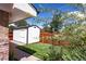 Backyard features a well-maintained lawn, a storage shed and a wooden fence for privacy at 4585 Hooker St, Denver, CO 80211