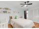 Bright bedroom with hardwood floors, ceiling fan, crib and decor at 4585 Hooker St, Denver, CO 80211