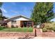 Charming brick ranch-style home with a well-manicured lawn and a beautiful mature tree at 4585 Hooker St, Denver, CO 80211