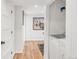 Hallway area with side-by-side washer and dryer plus luxury vinyl plank flooring at 4585 Hooker St, Denver, CO 80211