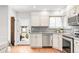 Bright kitchen featuring stainless steel appliances, granite countertops, and hardwood floors and backyard access at 4585 Hooker St, Denver, CO 80211