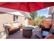 Outdoor patio area with a red umbrella, seating and outdoor decor at 4585 Hooker St, Denver, CO 80211