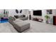 Basement entertainment area with comfortable sectional couch, tv, and speakers at 9724 Cantabria Pt, Lone Tree, CO 80124