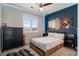 Tastefully decorated bedroom with a fan, dresser, and cozy bed at 9724 Cantabria Pt, Lone Tree, CO 80124