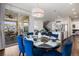 Dining room next to kitchen, featuring dining table, blue chairs, and views to living room at 9724 Cantabria Pt, Lone Tree, CO 80124
